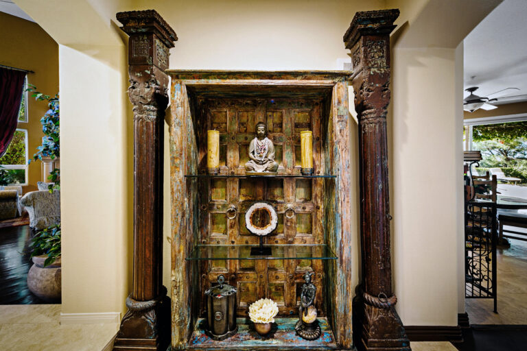 Spanish door with adjacent African wooden columns in West Hills Estate