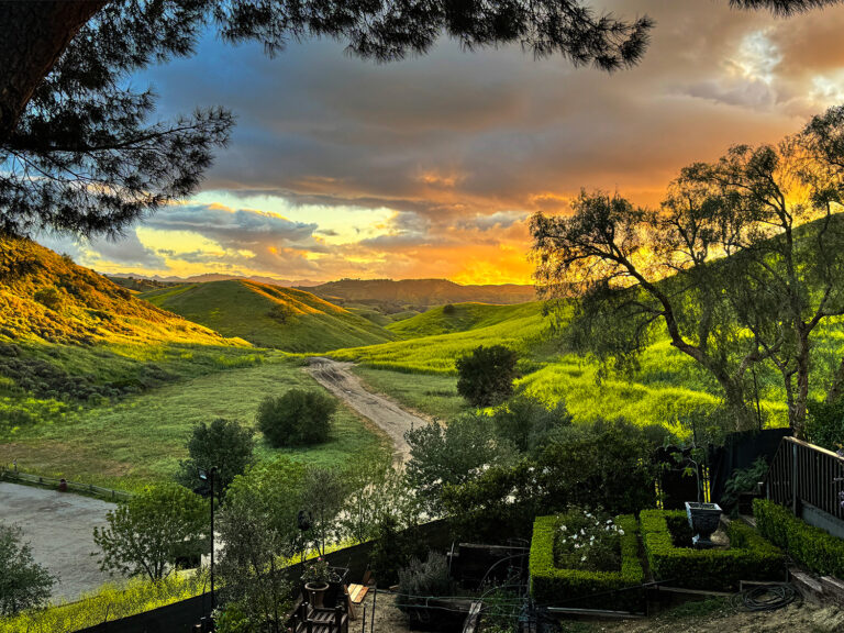 Golden-hour sunset over rolling hills and private garden at West Valley Estate in West Hills, California.